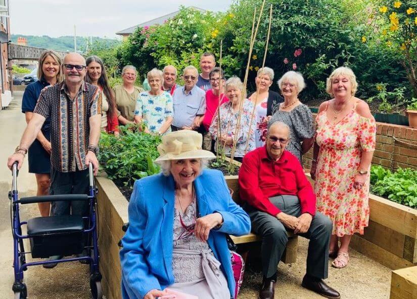 A group of people sitting down and standing up